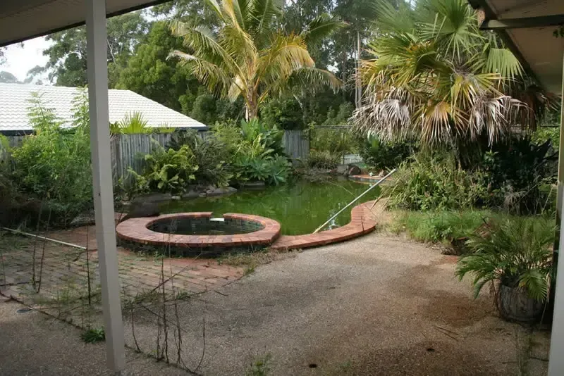 Backyard Garden With a Circular Brick Fire Pit — Mad Pool Interiors and Renovations in Baringa, QLD