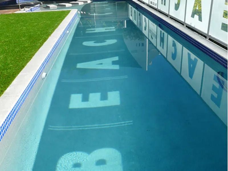 Blue Swimming Pool Lane With Large White Letters — Mad Pool Interiors and Renovations in Baringa, QLD