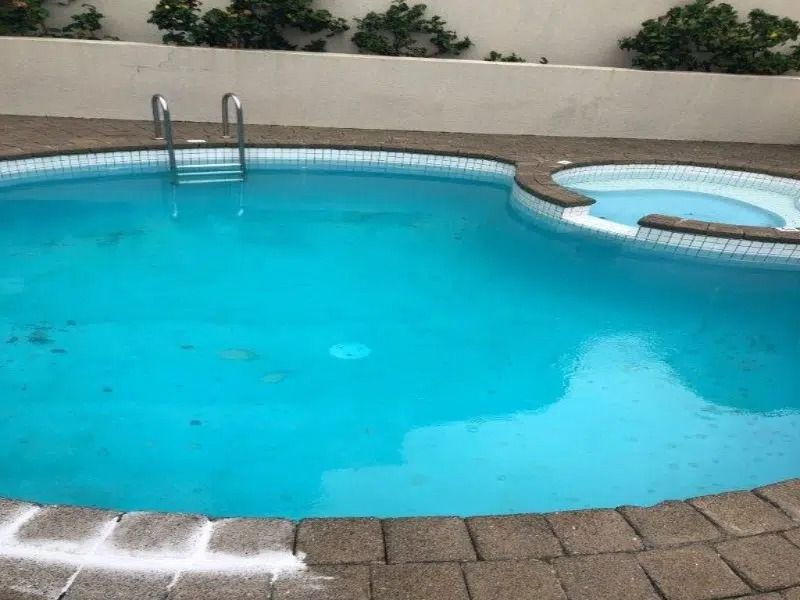 Blue Swimming Pool With Diving Board — Mad Pool Interiors and Renovations in Baringa, QLD