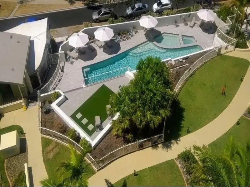 Aerial View of a Backyard Pool With White Umbrellas — Mad Pool Interiors and Renovations in Baringa, QLD