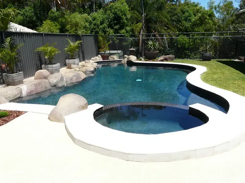 Backyard Swimming Pool With a Round SPA — Mad Pool Interiors and Renovations in Baringa, QLD