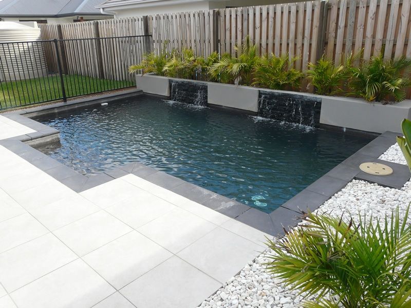 A Dark-bottomed Rectangular Pool With Waterfalls — Mad Pool Interiors and Renovations in Baringa, QLD