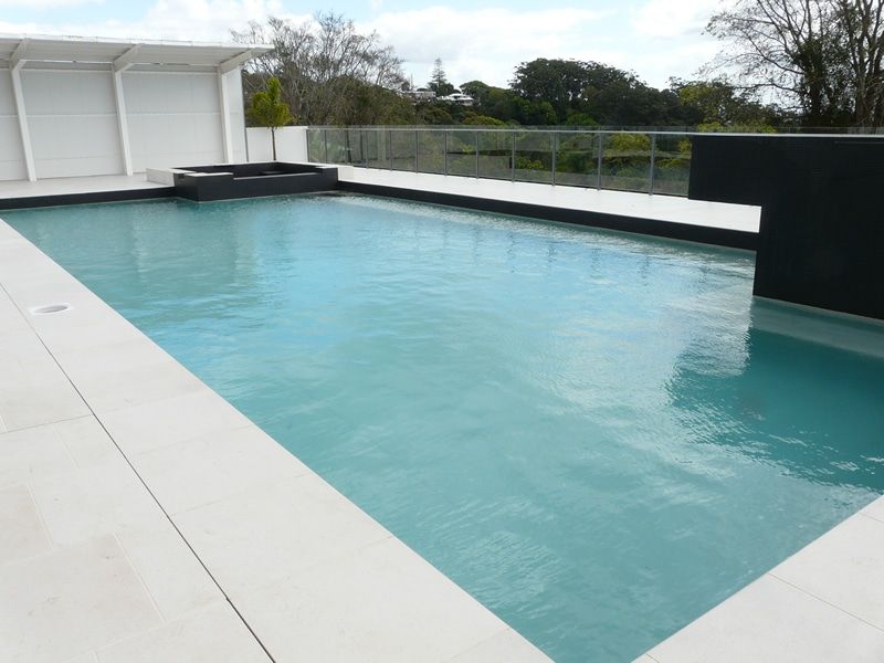 Rectangular Swimming Pool With Light Blue Water and White Tile Surround — Mad Pool Interiors and Renovations in Baringa, QLD
