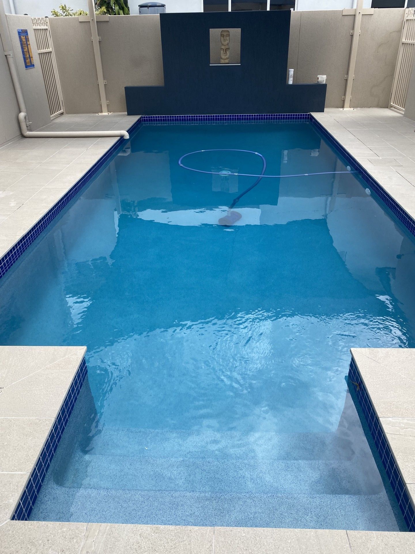 Blue Indoor Swimming Pool With Steps and a Raised Platform — Mad Pool Interiors and Renovations in Baringa, QLD