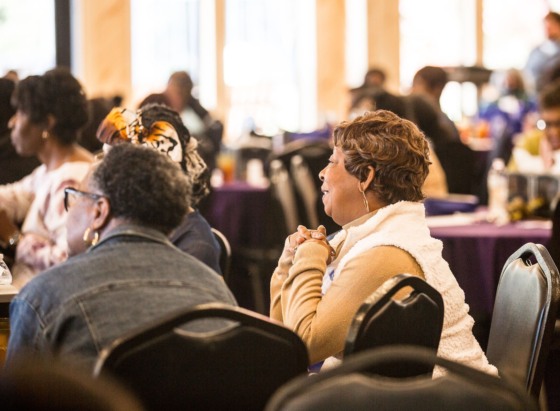 A group of people are sitting at tables in a room.