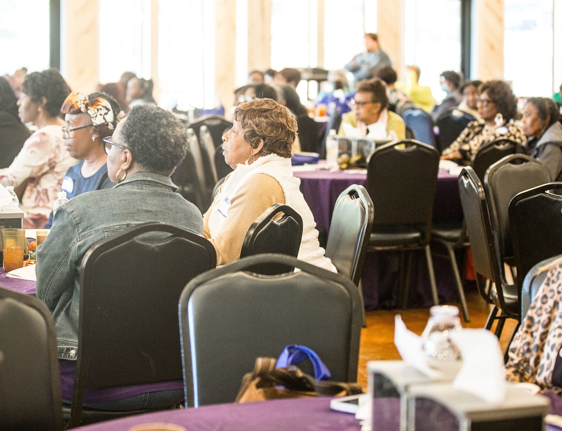 A group of people are sitting at tables in a room.