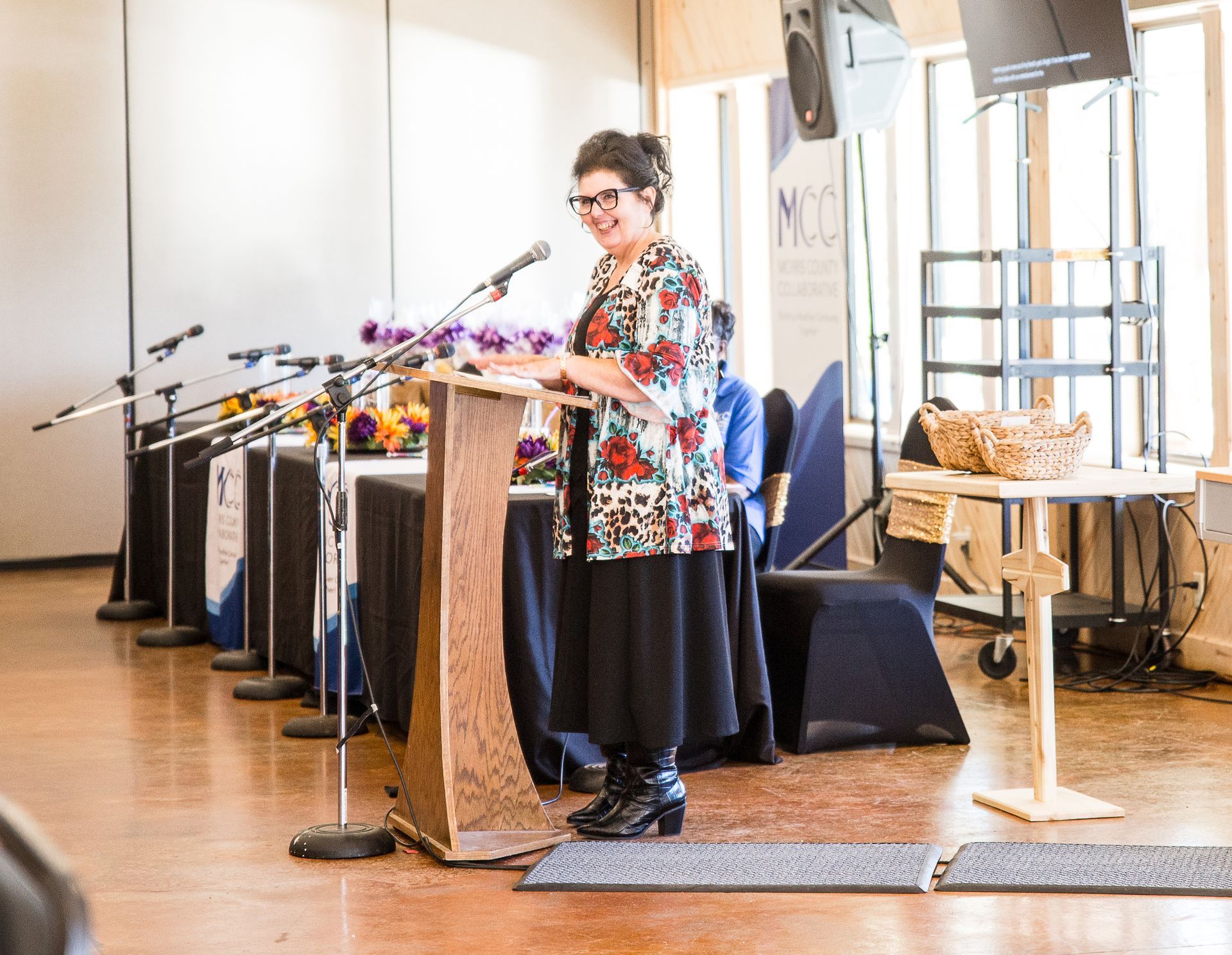 A woman is standing at a podium giving a speech.