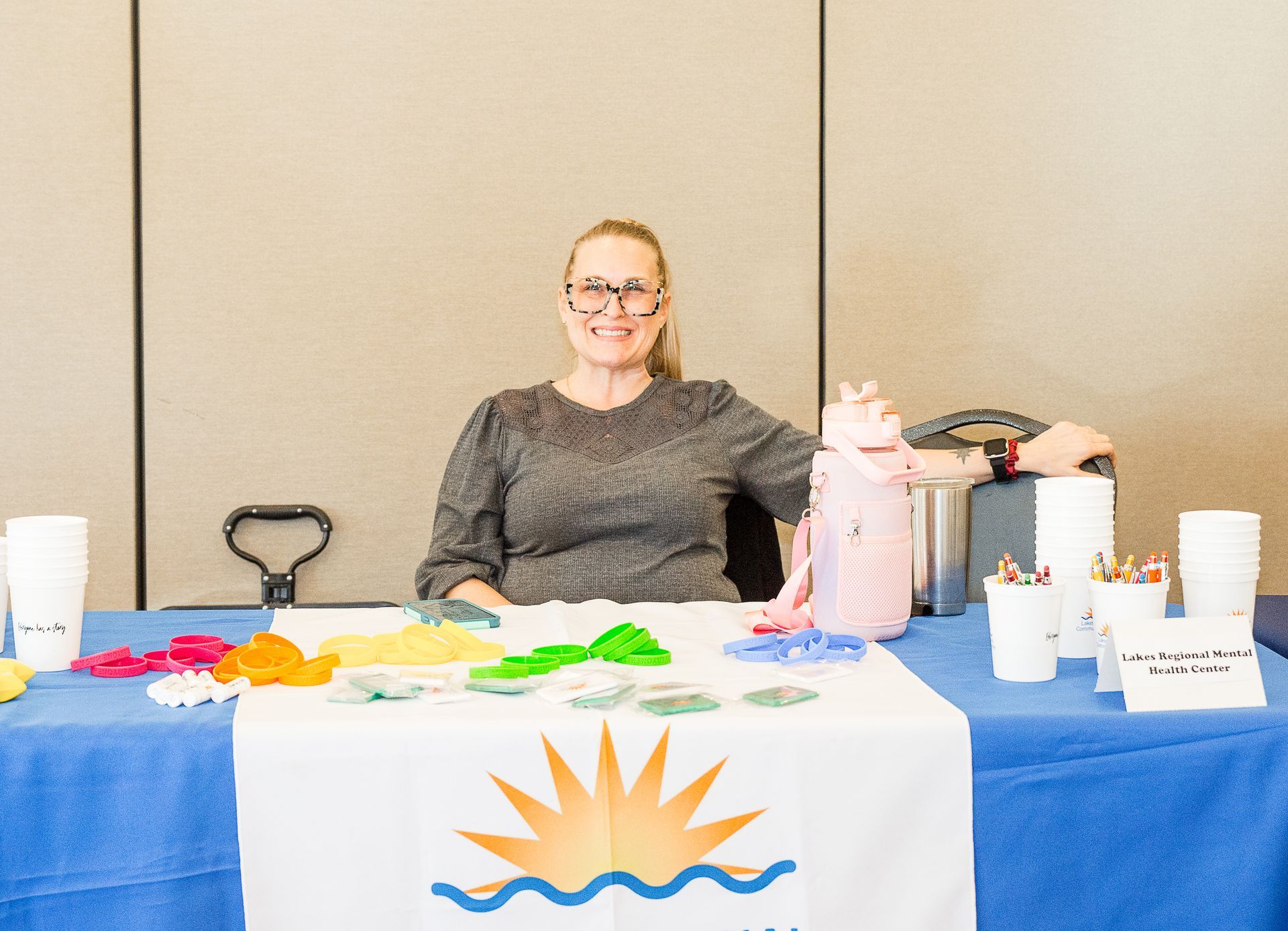 A woman is sitting at a table with a sun on it.
