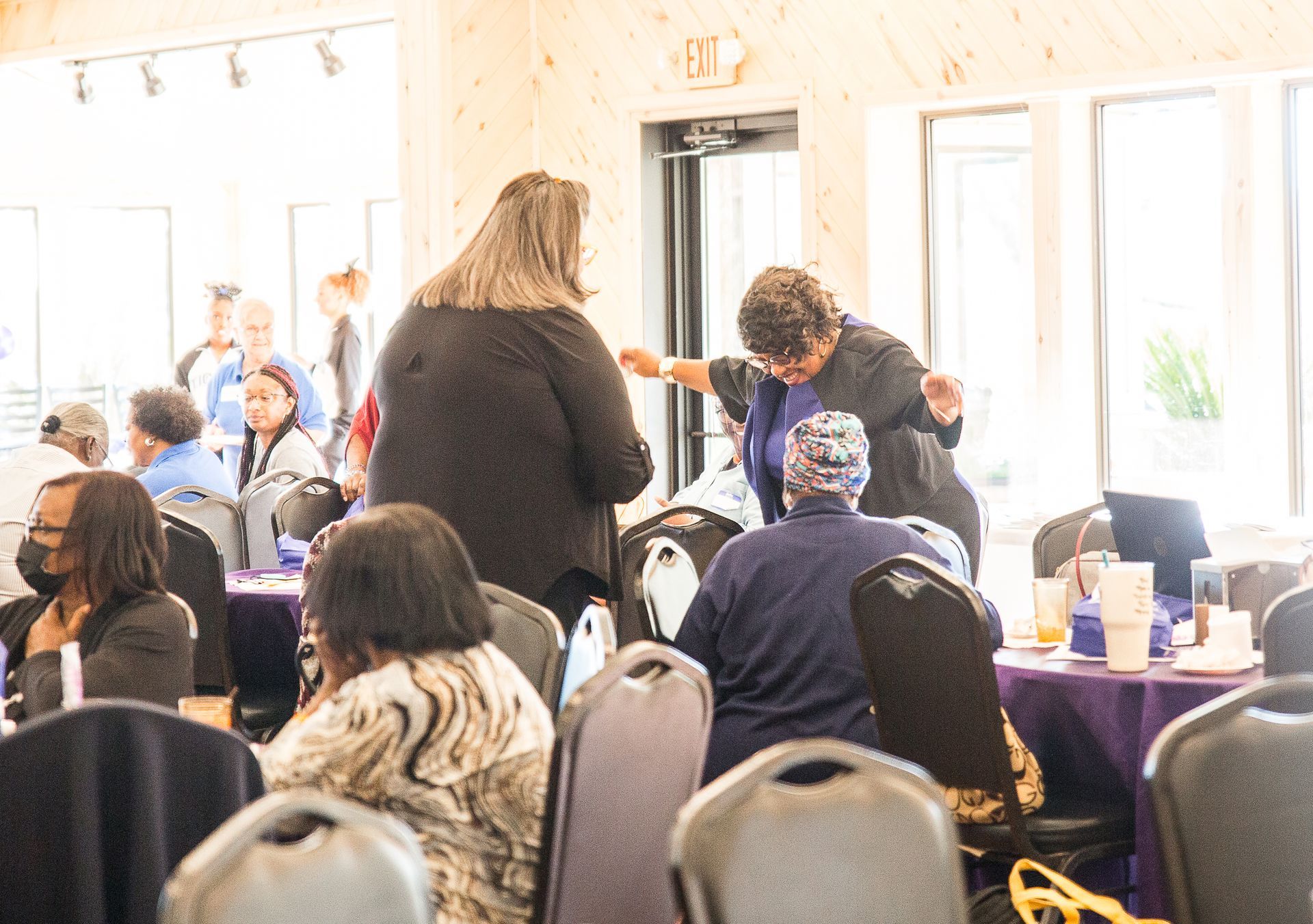 A group of people are sitting at tables in a room.