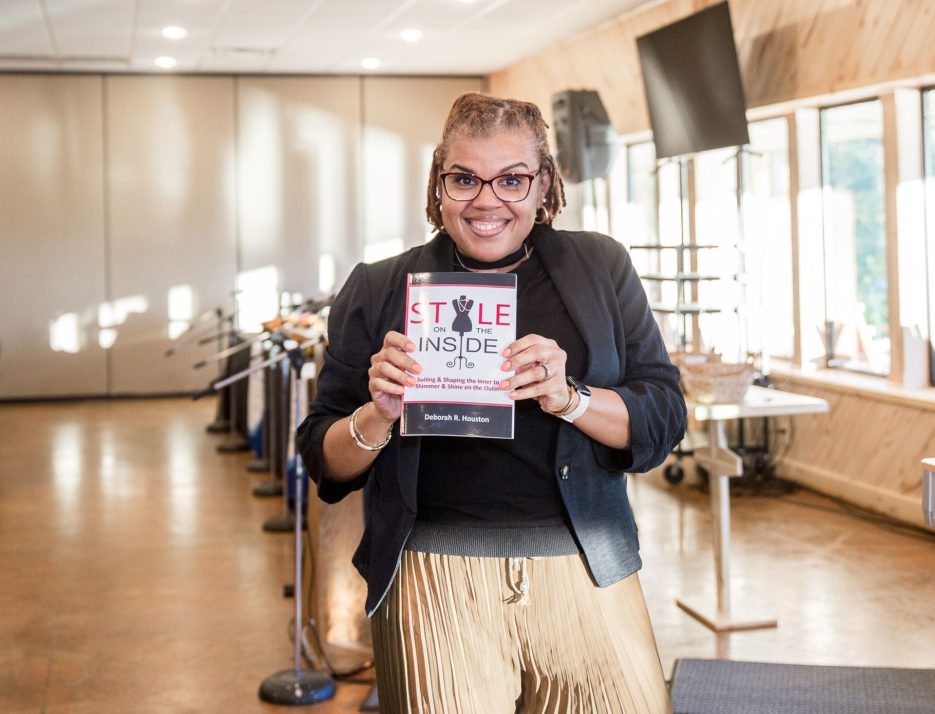 A woman is holding a book titled style inside.