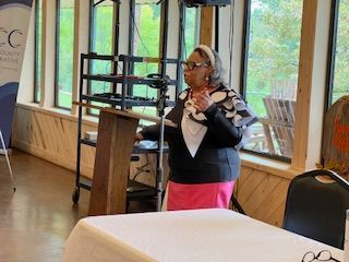 A woman is standing at a podium giving a speech.