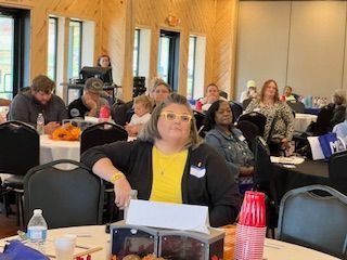 A group of people are sitting at tables in a room.
