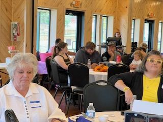 A group of people are sitting at tables in a room.