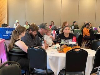 A group of people are sitting at tables in a room.