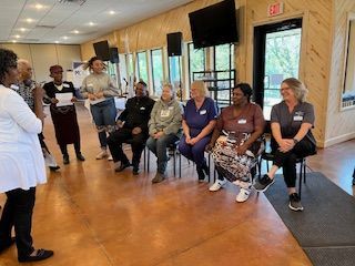 A group of people are sitting in chairs in a room.