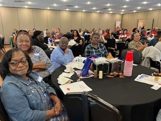 A group of people are sitting at tables in a room.