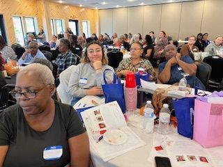 A group of people are sitting at tables in a room.
