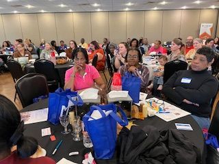 A group of people are sitting at tables in a room.