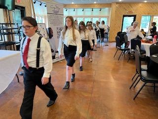 A group of people are walking down a hallway.