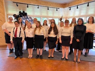 A group of people are posing for a picture in a room.