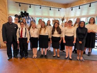 A group of people are posing for a picture in a room.