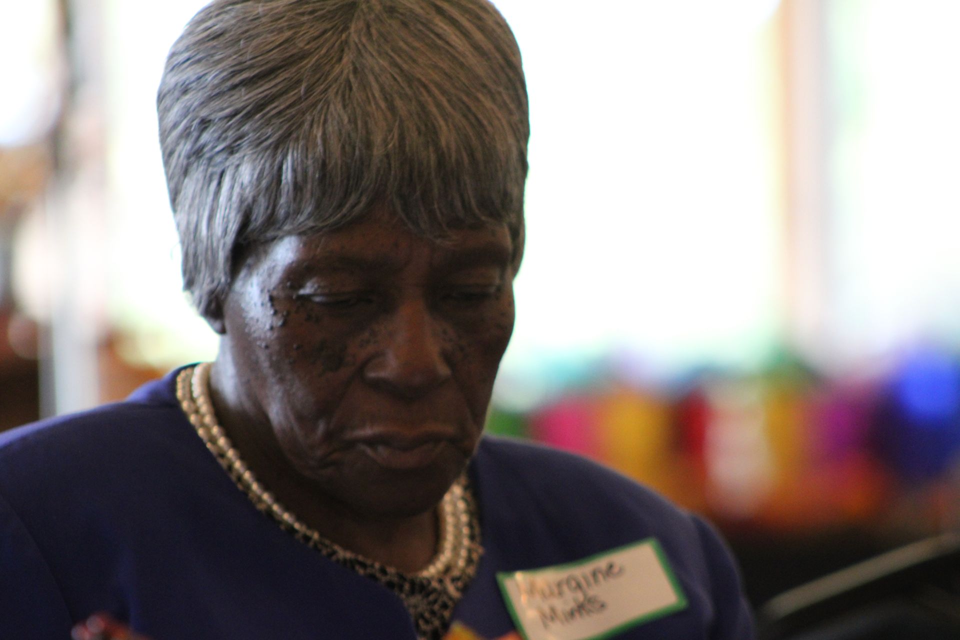 A woman wearing a name tag that says harriet smith