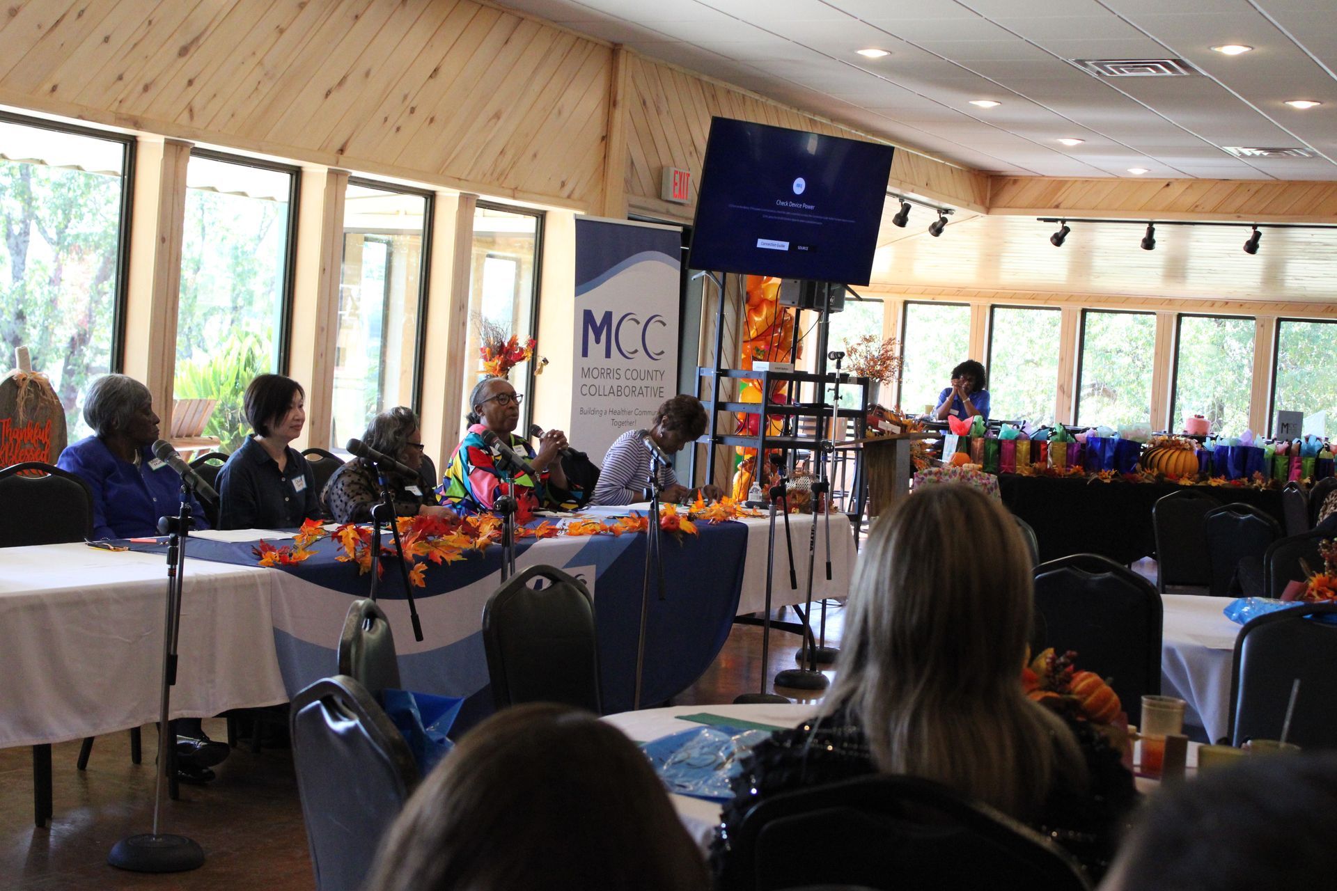 A group of people are sitting at tables in a room.