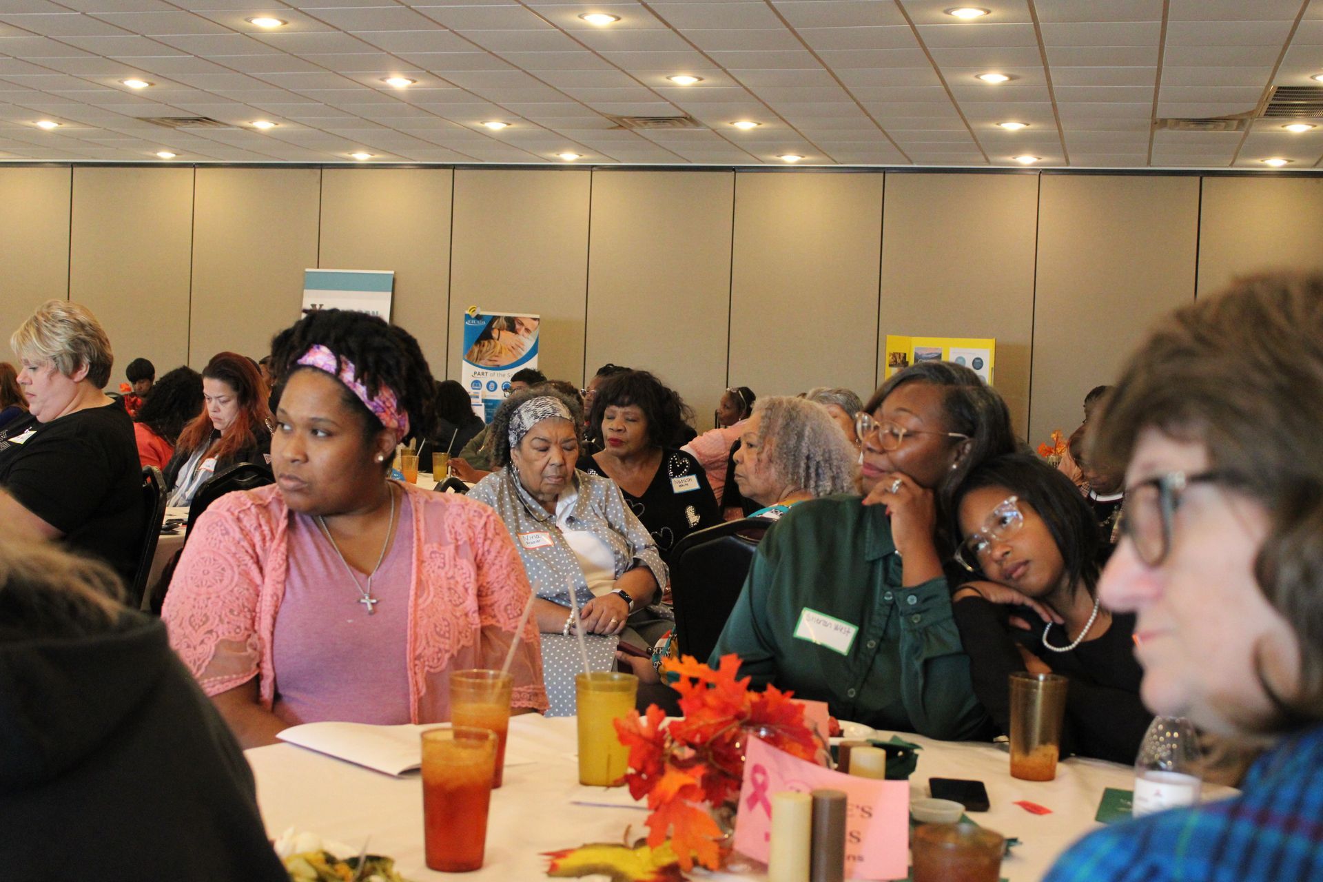 A group of people are sitting at tables in a room.