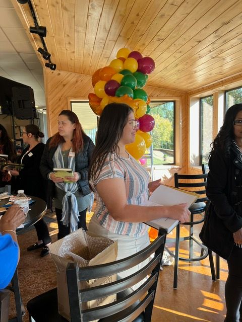 A woman is standing in front of a bunch of balloons