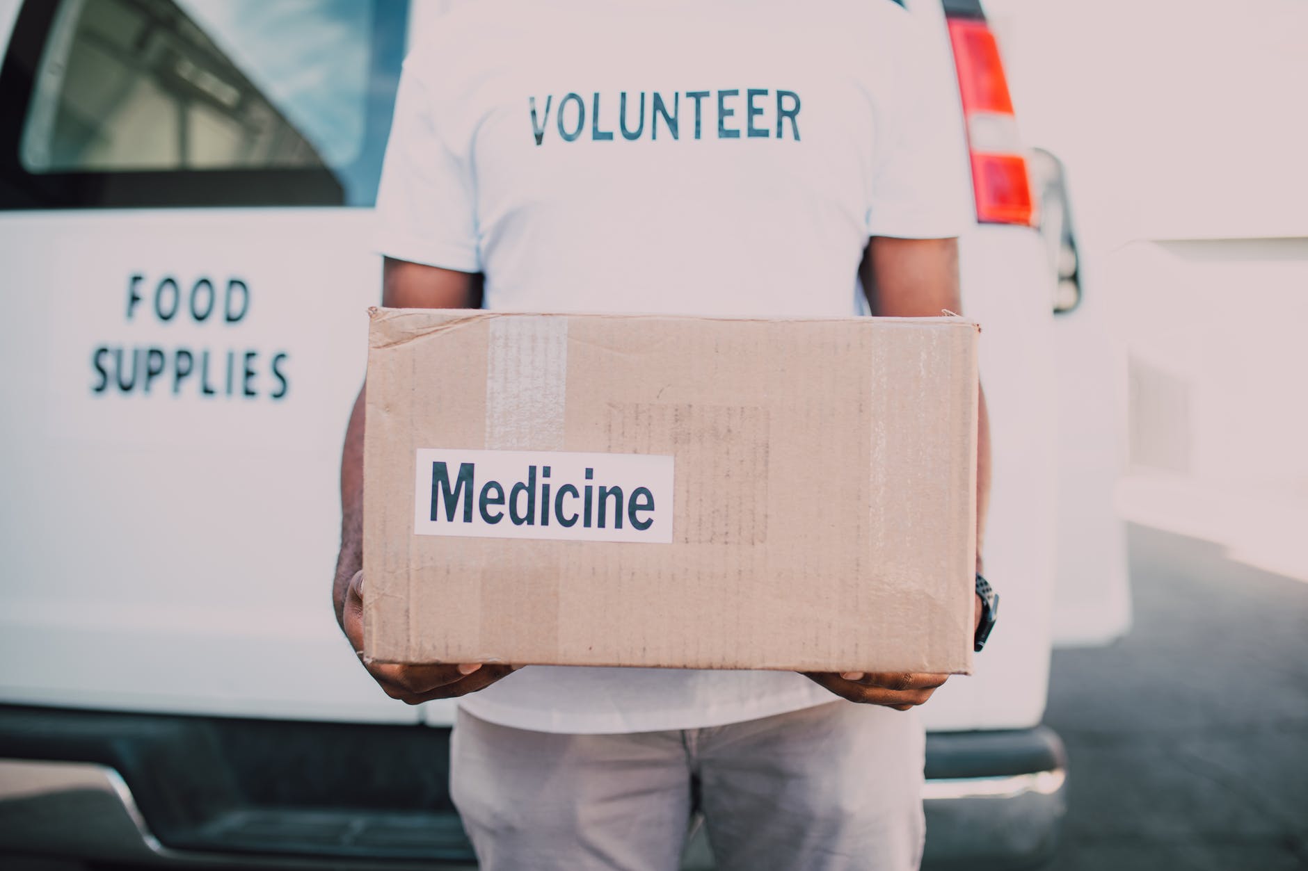 volunteer holding medicine pack box