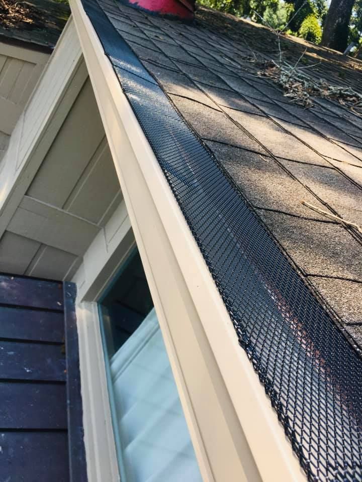 A close up of a gutter on the roof of a house.