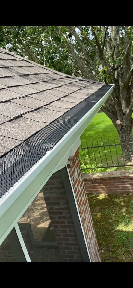 A close up of a gutter on the side of a house.