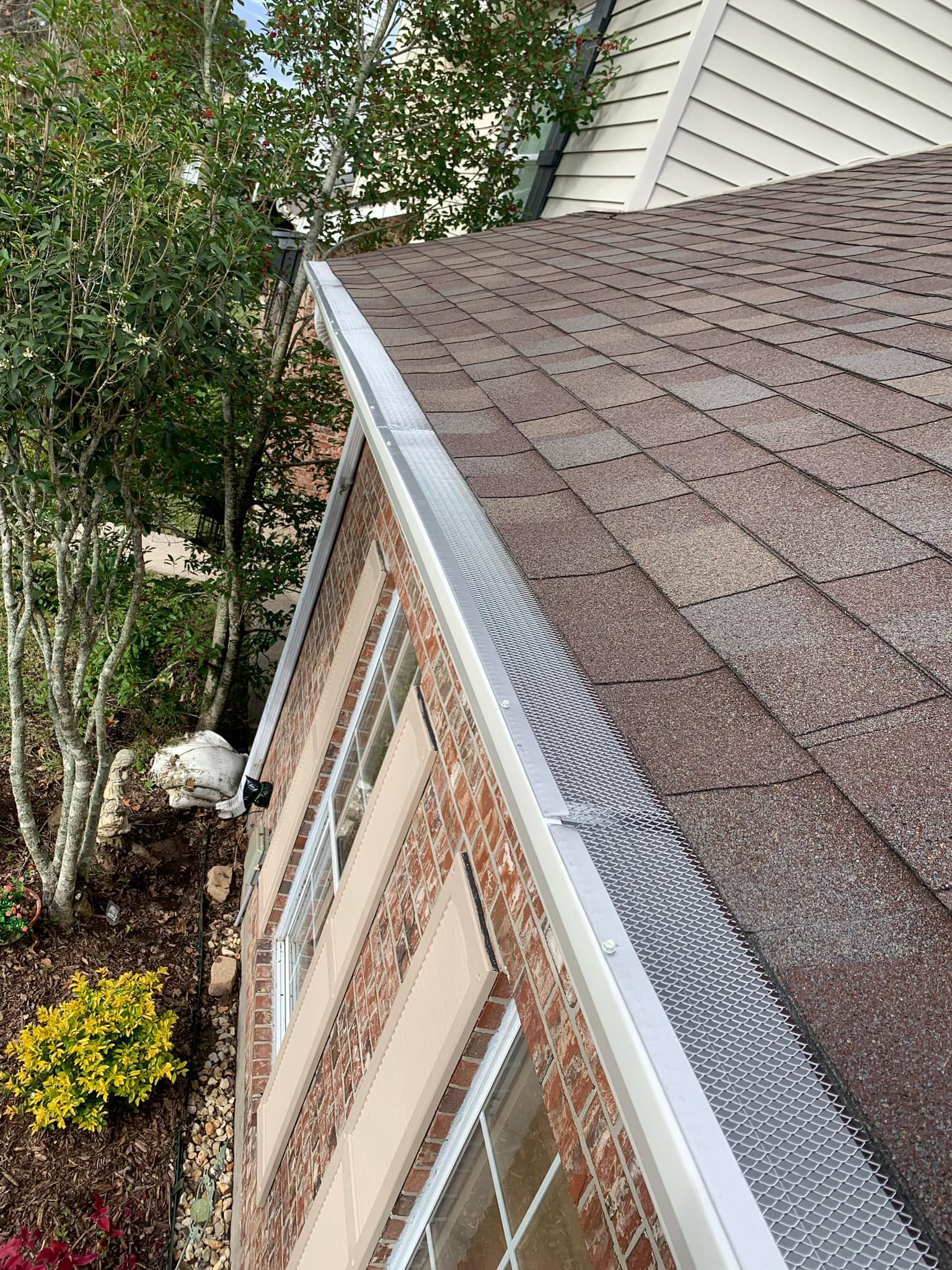 A close up of a gutter on the side of a house.