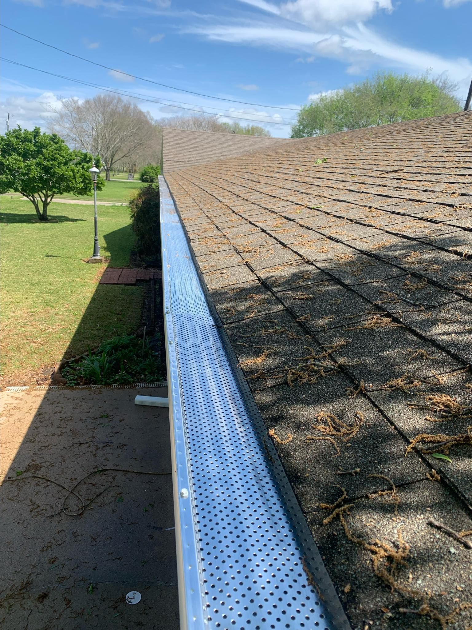A close up of a gutter on the side of a roof.
