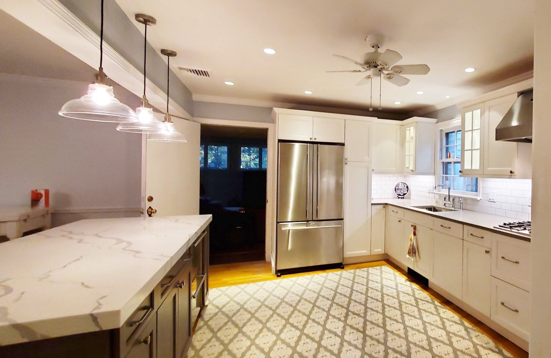 A kitchen with stainless steel appliances and white cabinets