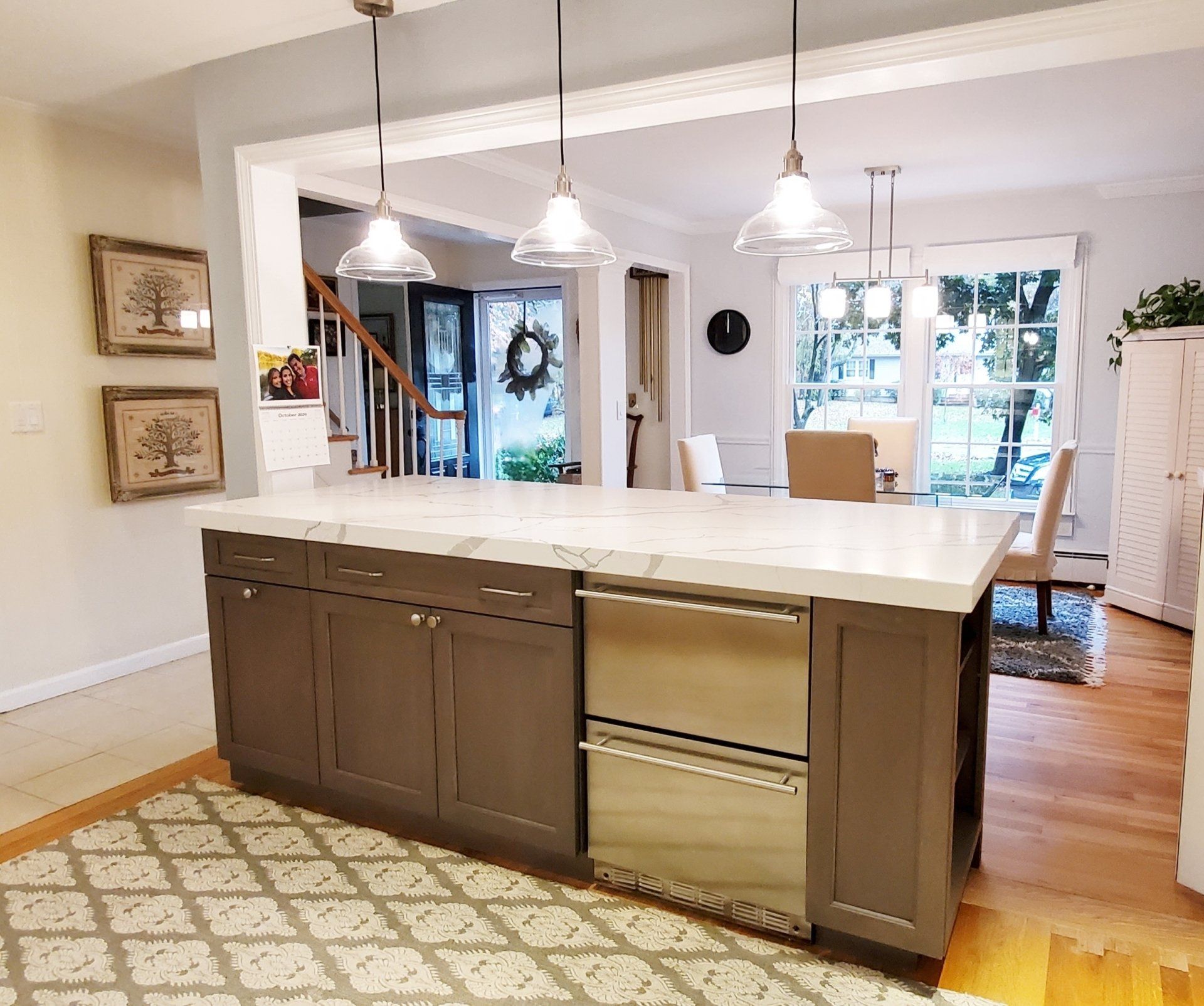 A kitchen with a large island and stainless steel appliances.