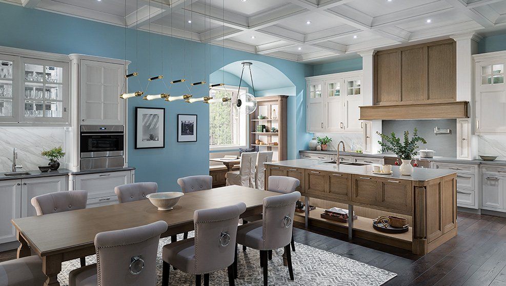 A kitchen with a dining table and chairs in it.