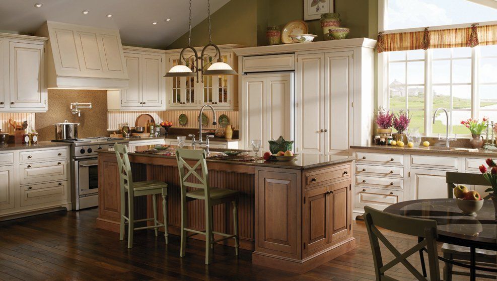 A kitchen with white cabinets and a large island
