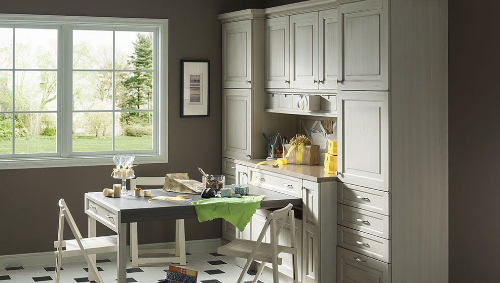 A kitchen with a table and chairs and a window.