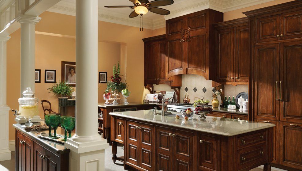 A kitchen with a large island and a ceiling fan