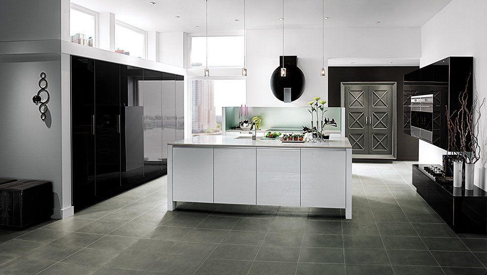 A black and white kitchen with a large island in the middle