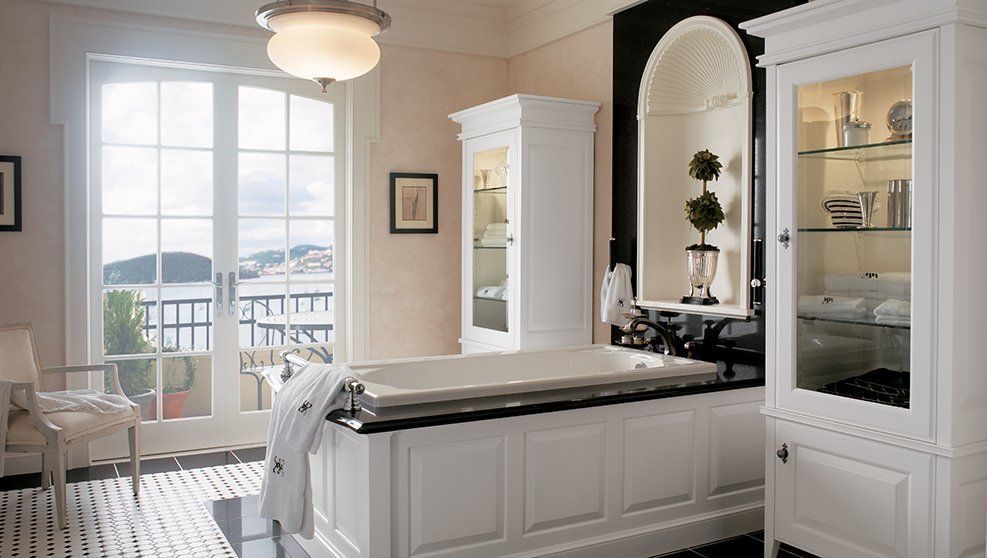 A bathroom with a large tub and a large window