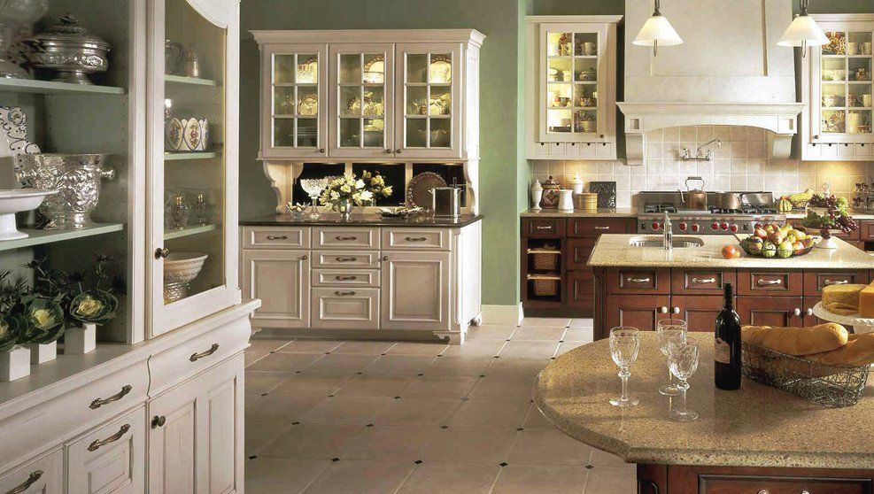 A kitchen with white cabinets and a large island