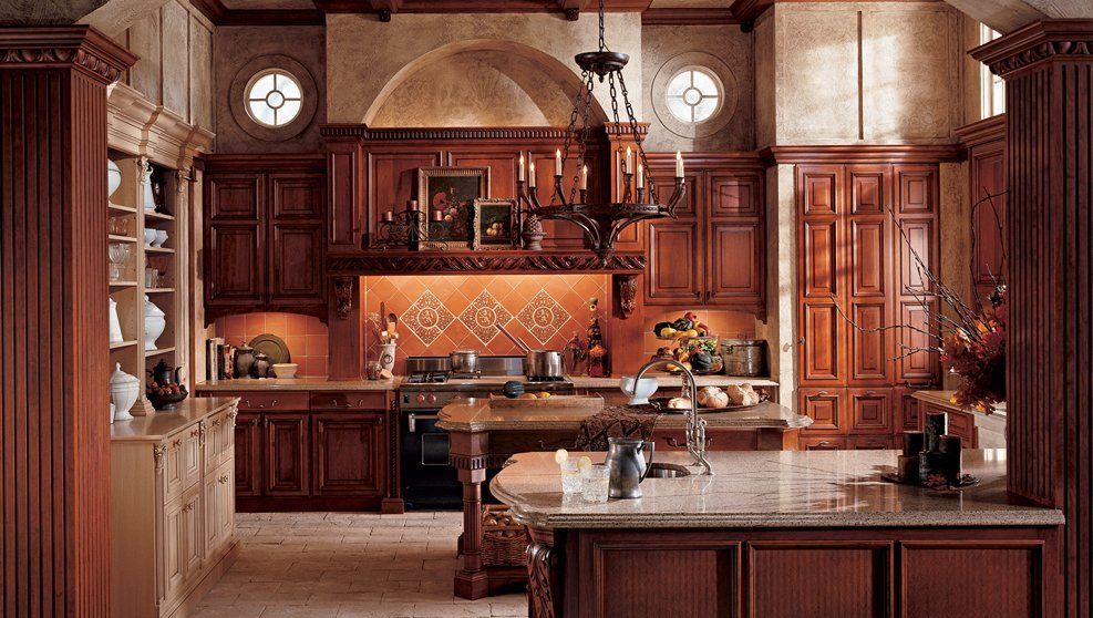A kitchen with wooden cabinets and a large island
