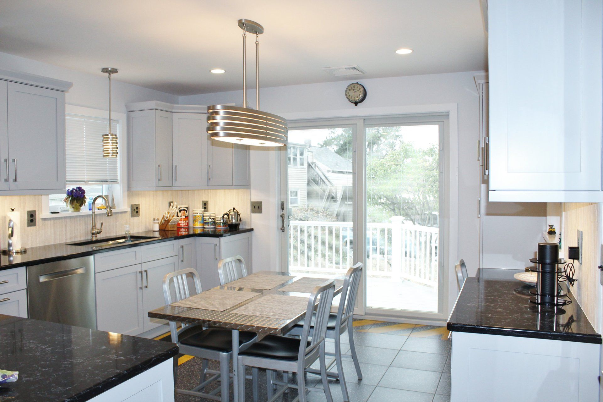 A kitchen with a table and chairs and a sliding glass door