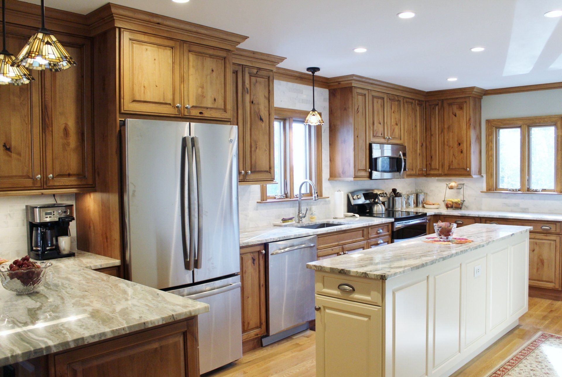 A kitchen with stainless steel appliances and wooden cabinets
