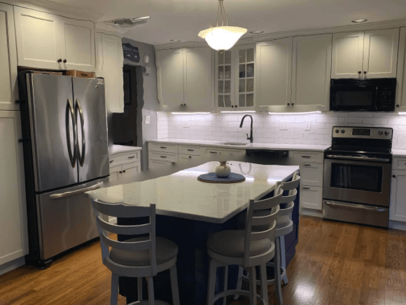 A kitchen with white cabinets and stainless steel appliances