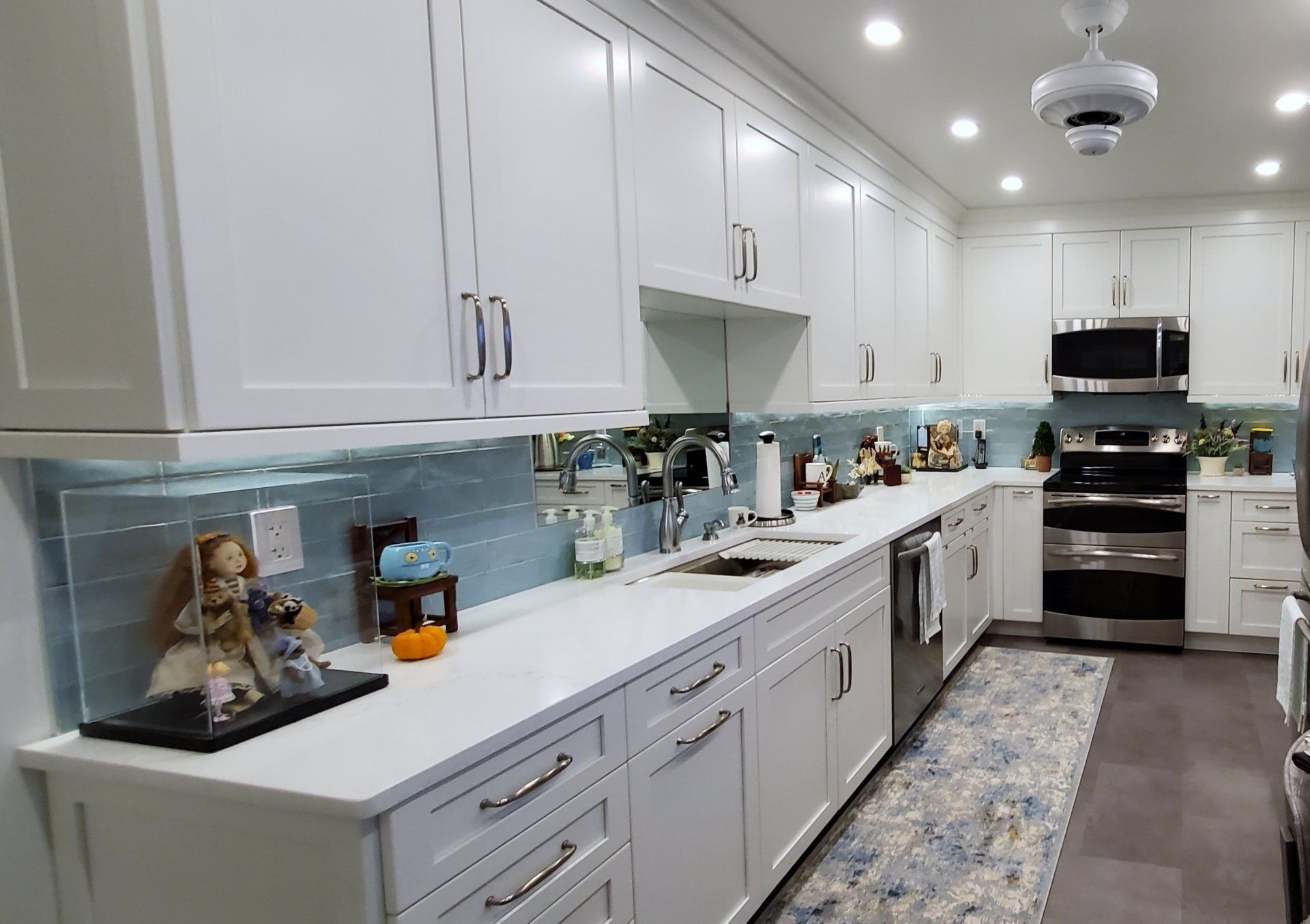 A kitchen with white cabinets and stainless steel appliances