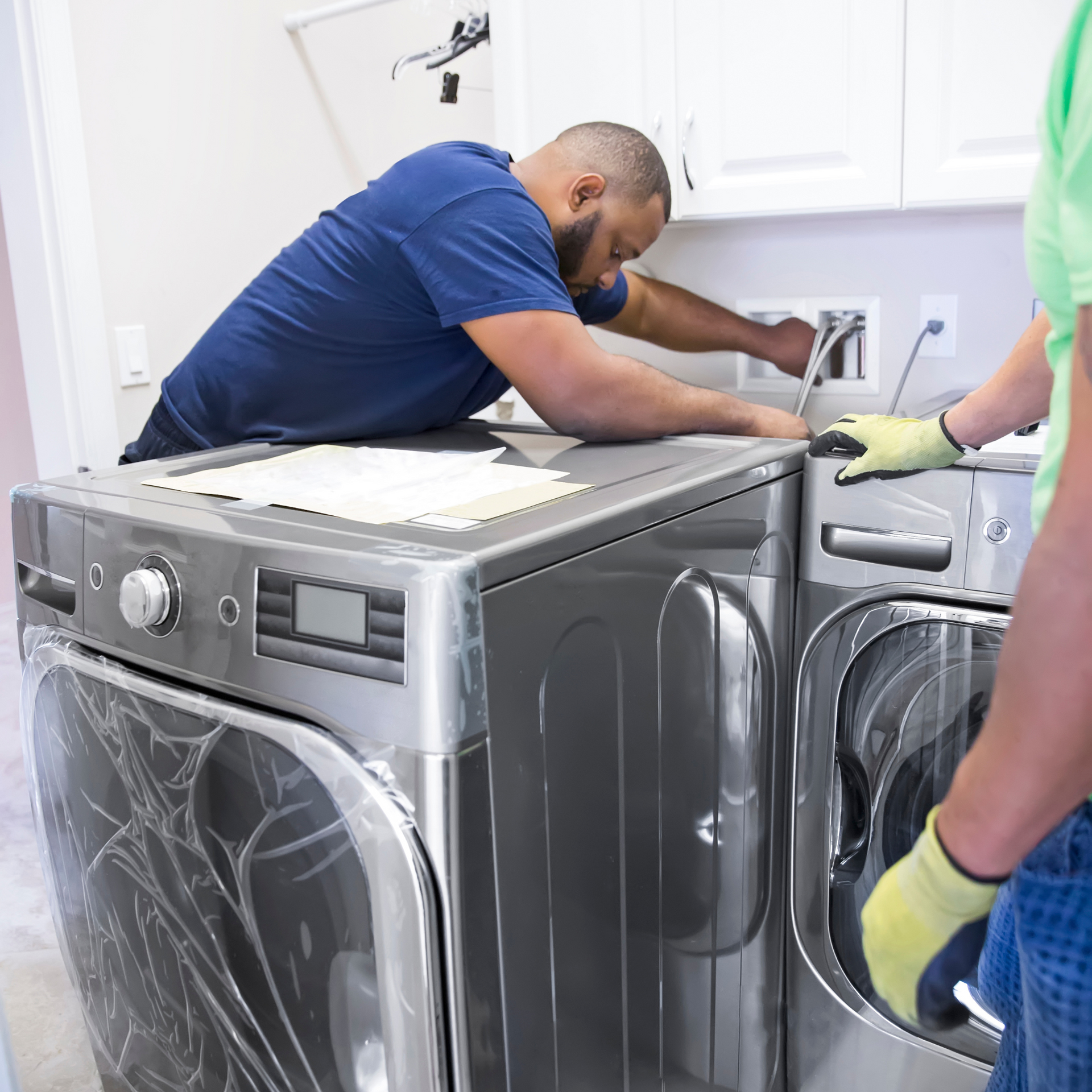 Mid - Cape Appliance - working on a washing machine in a laundry room