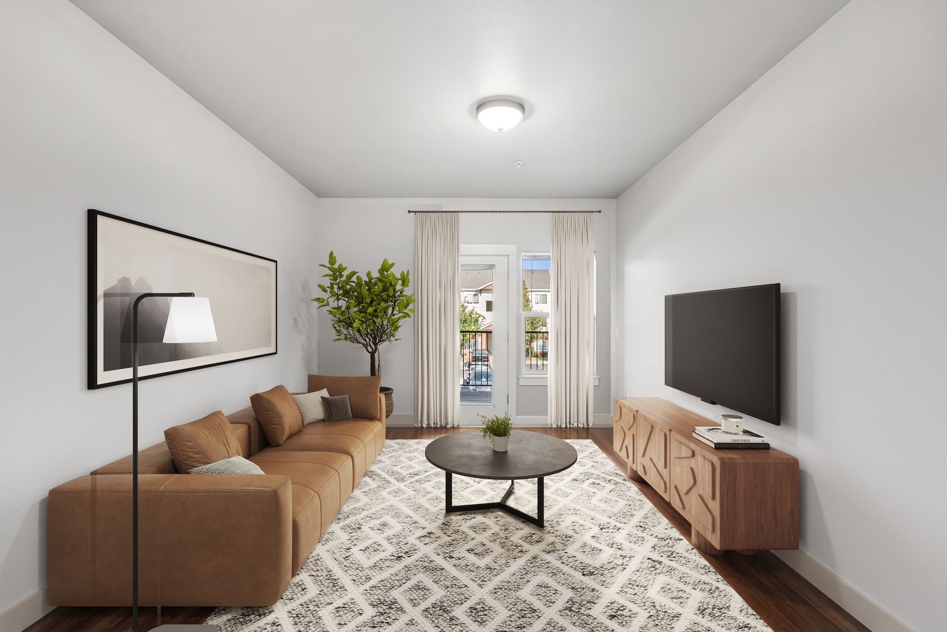 Living room with brown sectional, TV, rug, and door to outside.